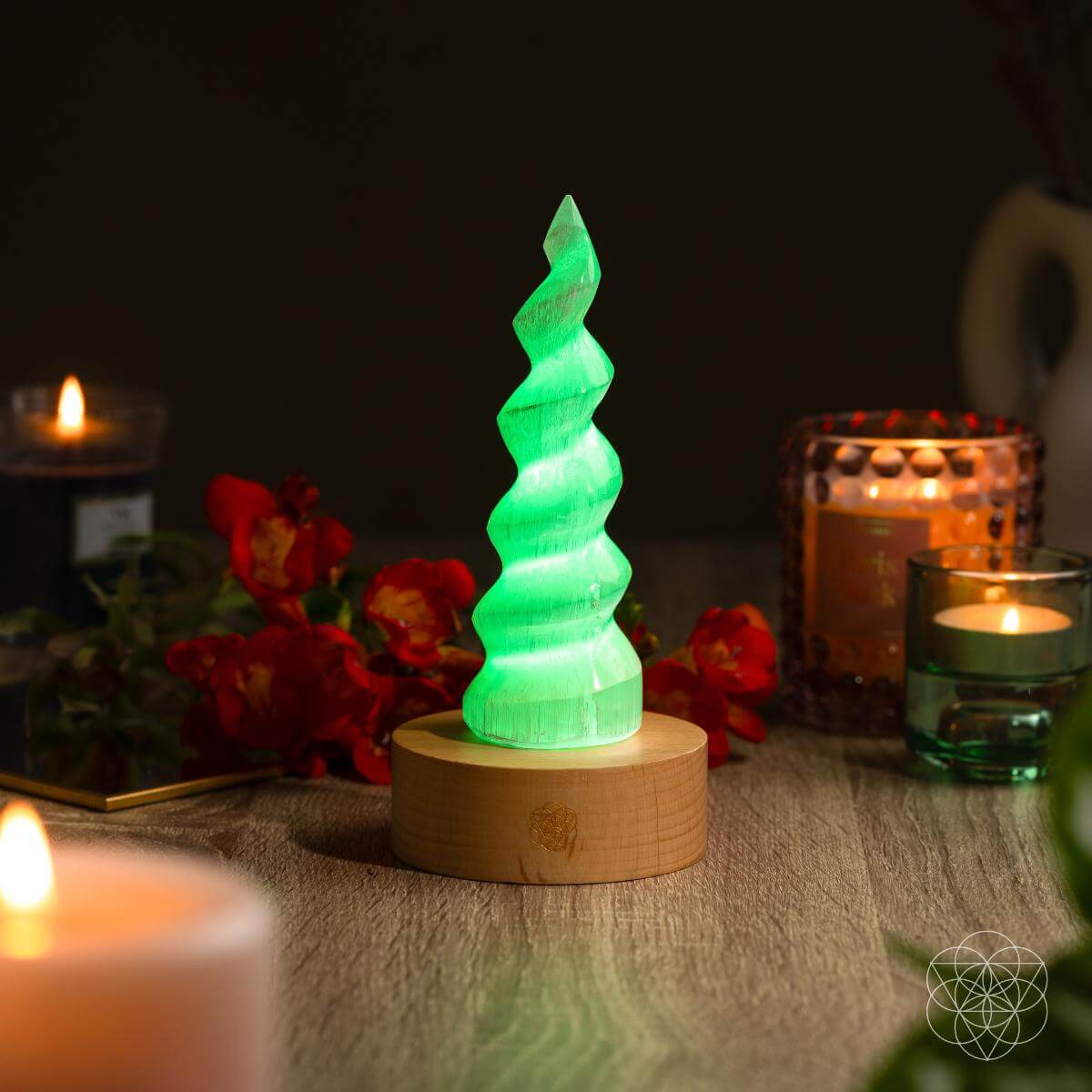 Handmade selenite flame lamp rising from a wooden base, lit in soft color — detail view 6