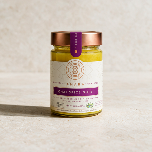 Ahara Rasa Chai Spice ghee in the 10 fl oz jar with a copper lid and magenta label on pale stone