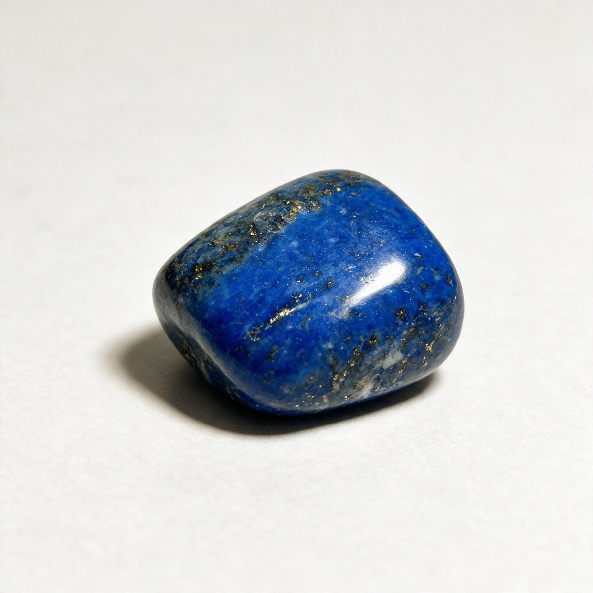 The same lapis lazuli pocket stone from a second angle, its polished faces catching the light