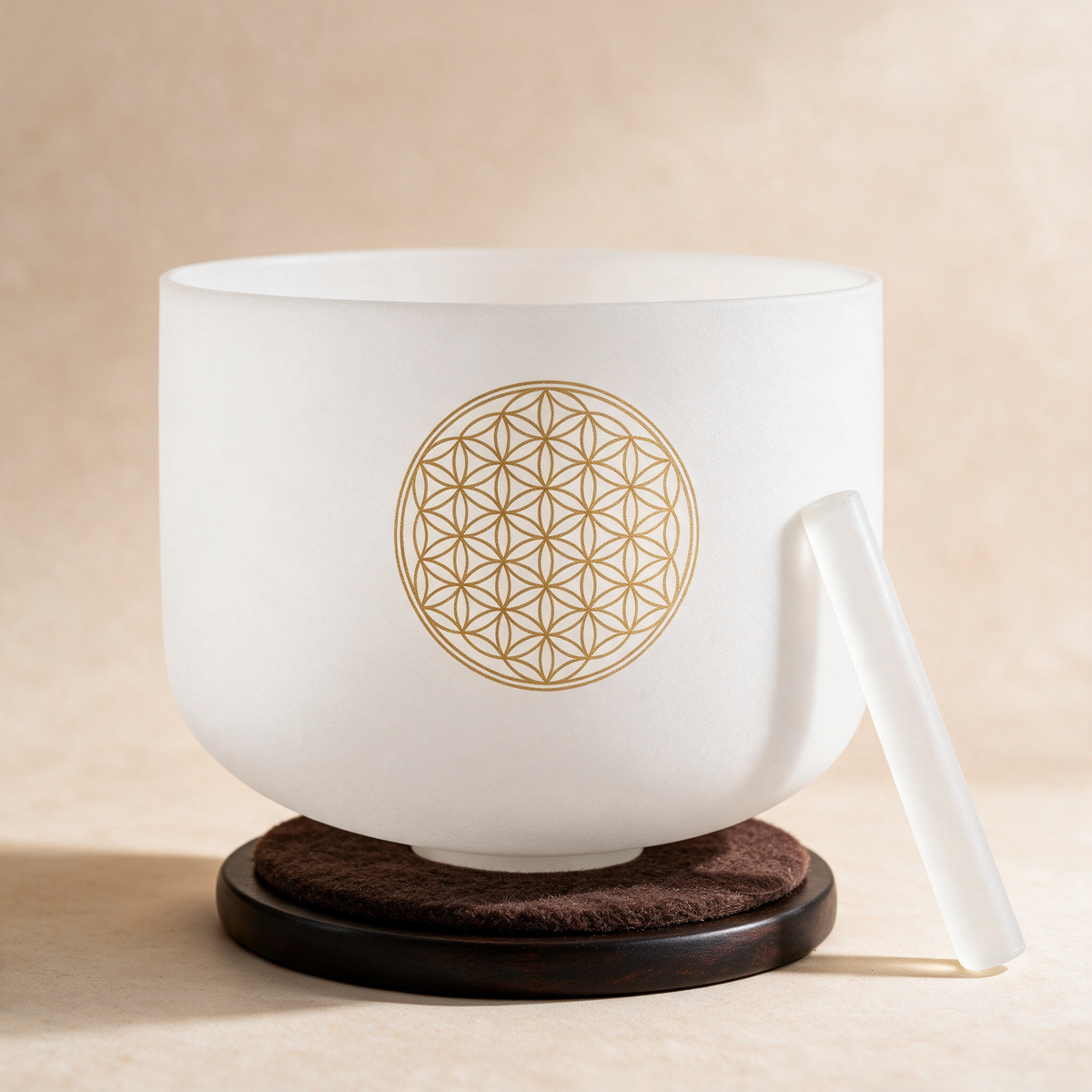16-inch crystal singing bowl on a dark cork ring base with its white mallet leaning against the side