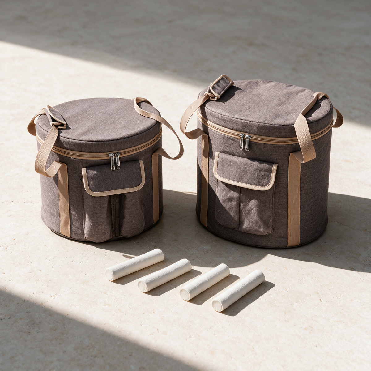 Both padded carry bags standing side by side with the set's white mallets laid out in front of them