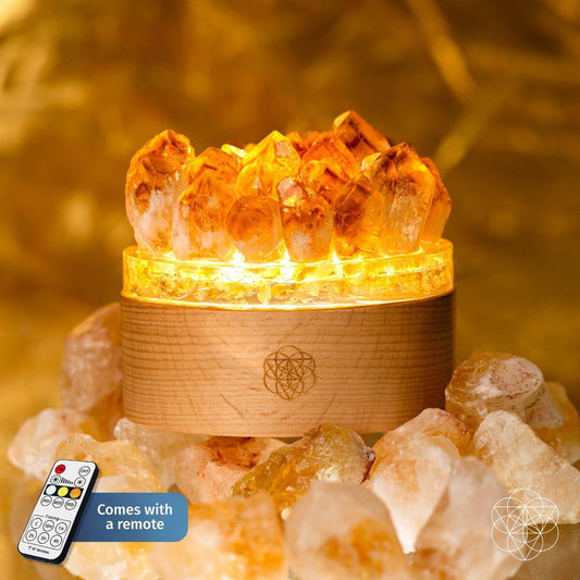 Citrine crystal lamp with golden points rising from a wooden base
