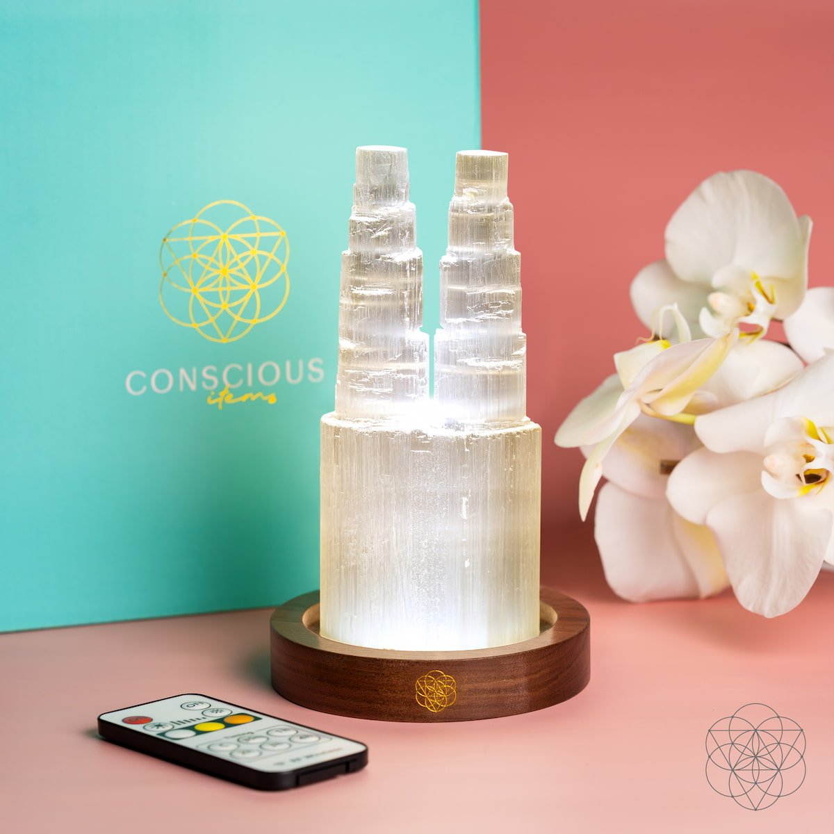 Two carved Selenite towers glowing side by side on a wooden base — view 6
