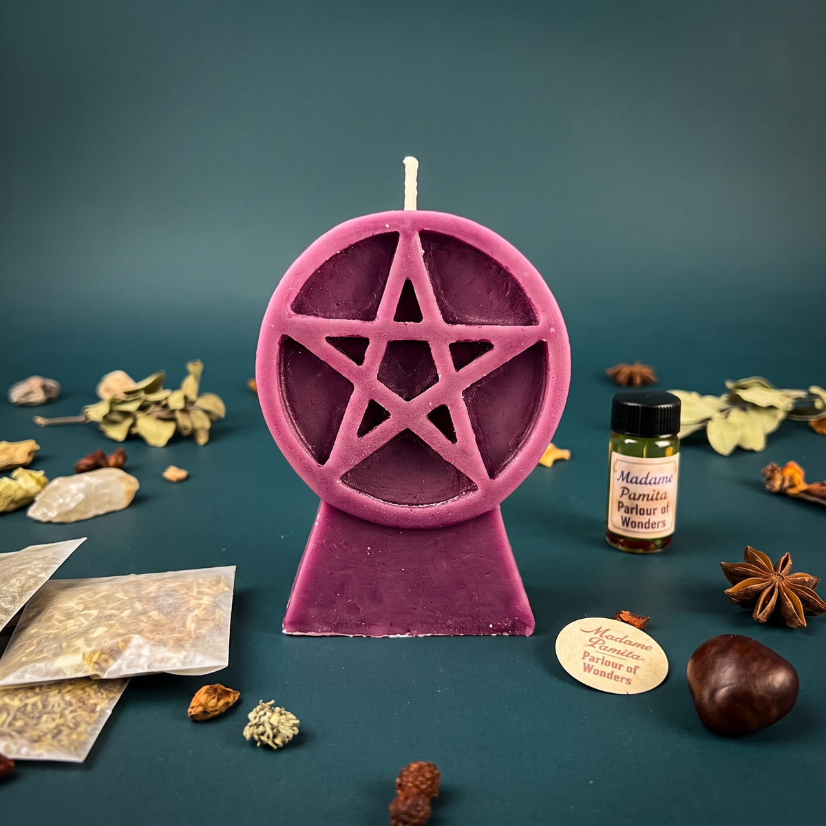 Pentacle of Protection candle spell kit with a pink beeswax pentacle candle, oil and herbs on a teal backdrop