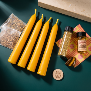Triumph Candle Spell Booster Pack with four yellow beeswax taper candles, Grand Success oil, herbs, a tumbled gemstone and glass glitter
