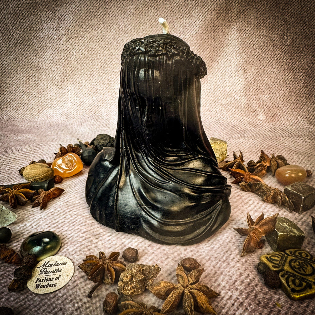 Veil of Secrets beeswax veiled figure candle in black with herbs and stones