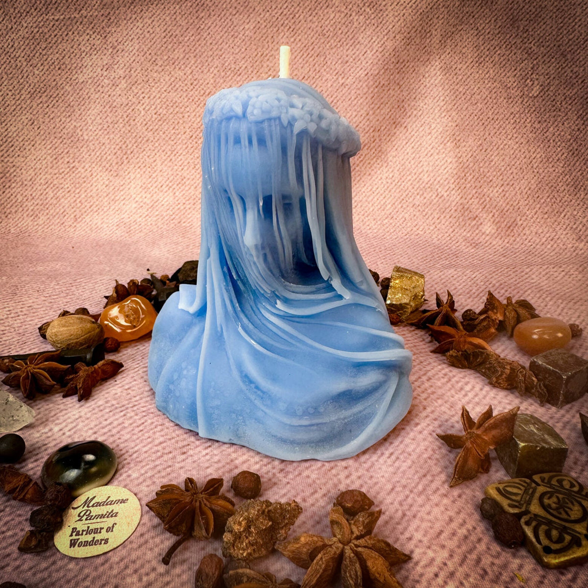 Veil of Secrets beeswax veiled figure candle in blue with herbs and stones