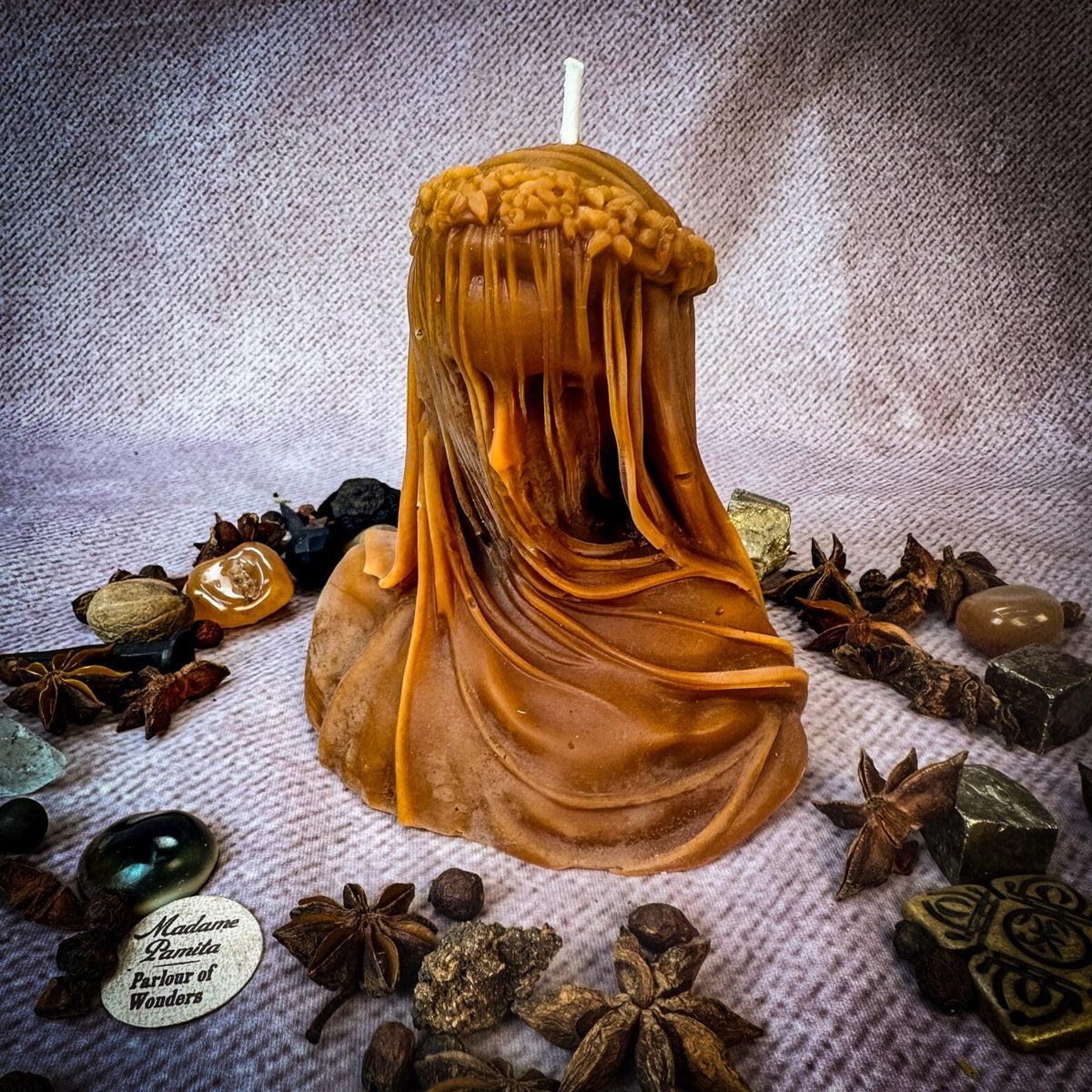 Veil of Secrets beeswax veiled figure candle in brown with herbs and stones