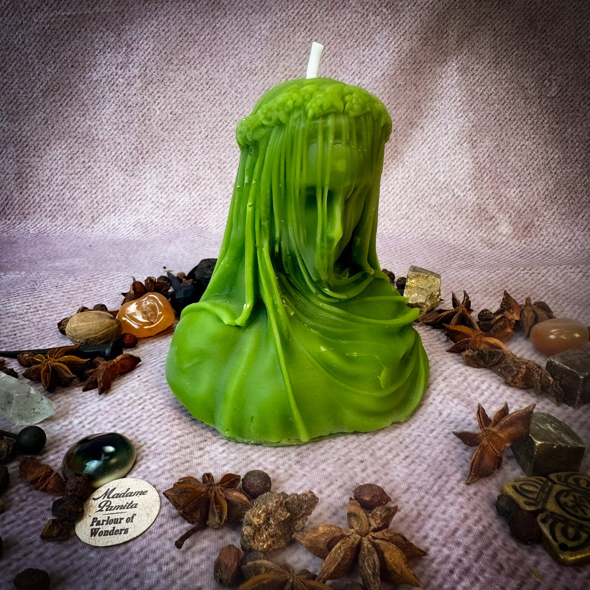 Veil of Secrets beeswax veiled figure candle in green with herbs and stones