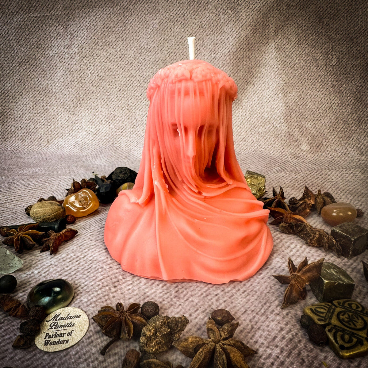 Veil of Secrets beeswax veiled figure candle in coral pink with herbs and stones